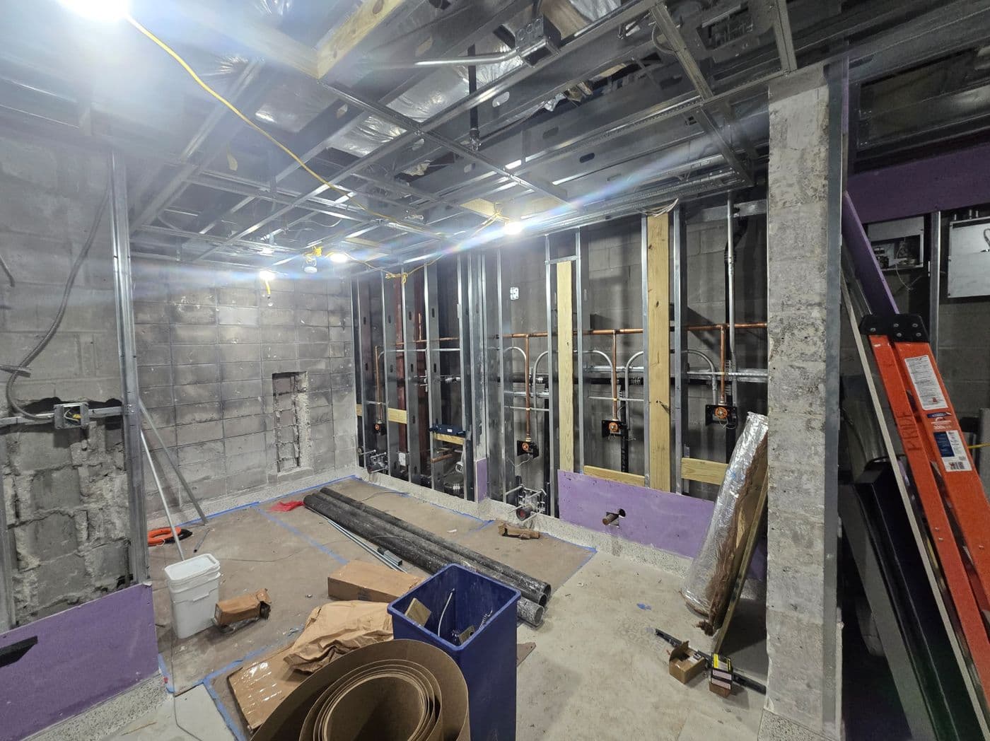 Multi-fixture plumbing rough-in inside a commercial tenant build-out